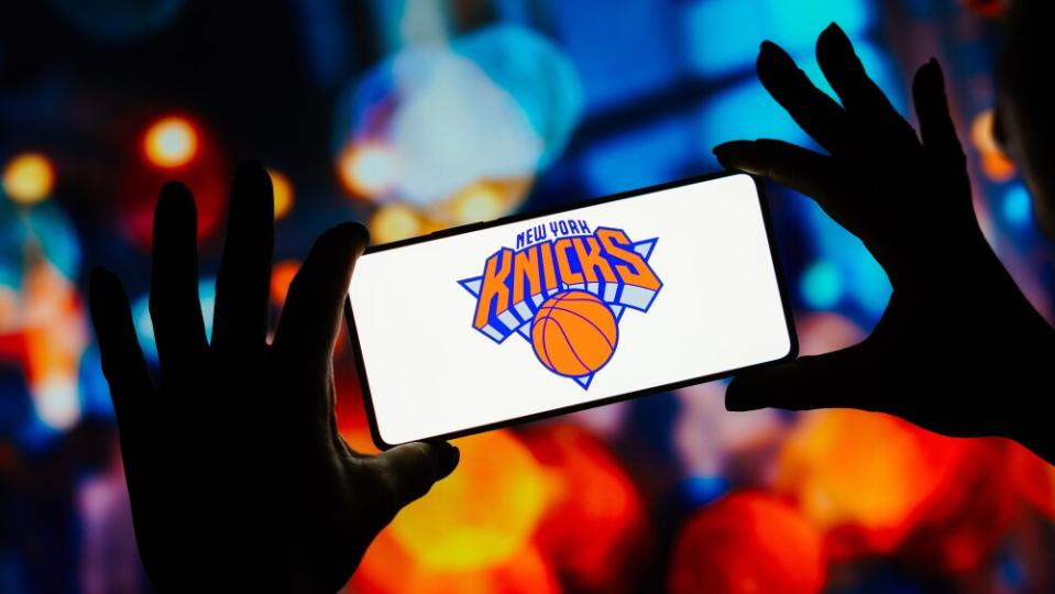 In this photo illustration, the New York Knicks logo is...
