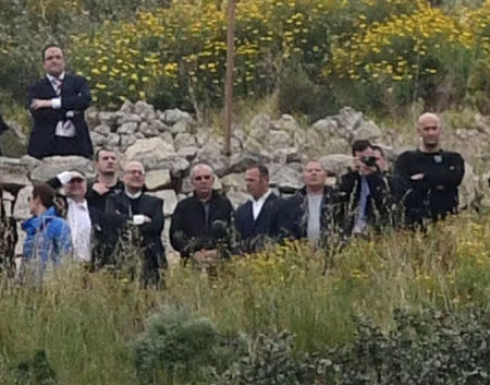 Vince Muscat (in sunglasses), Alfred Degiorgio (4R) and George Degiorgio (3rd R), the three men accused of the murder of anti-corruption journalist Daphne Caruana Galizia in a car bomb last October, attend an on-site inquiry during the compilation of evidence against them at part of the crime scene outside Bidnija, Malta April 18, 2018. REUTERS/Stringer
