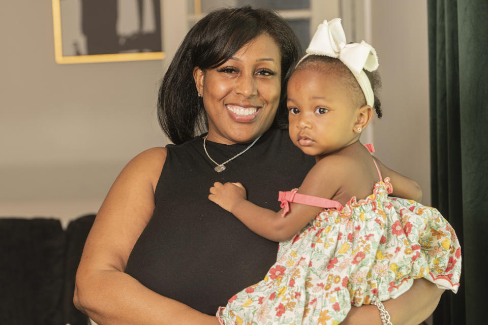 Raquel Robinson poses with her one-year-old daughter Londyn Crenshaw at their home in Cleveland Heights, Ohio, Wednesday, June 12, 2024. After her daughter was born in October 2022, Robinson was diagnosed with postpartum depression.(AP Photo/Phil Long)