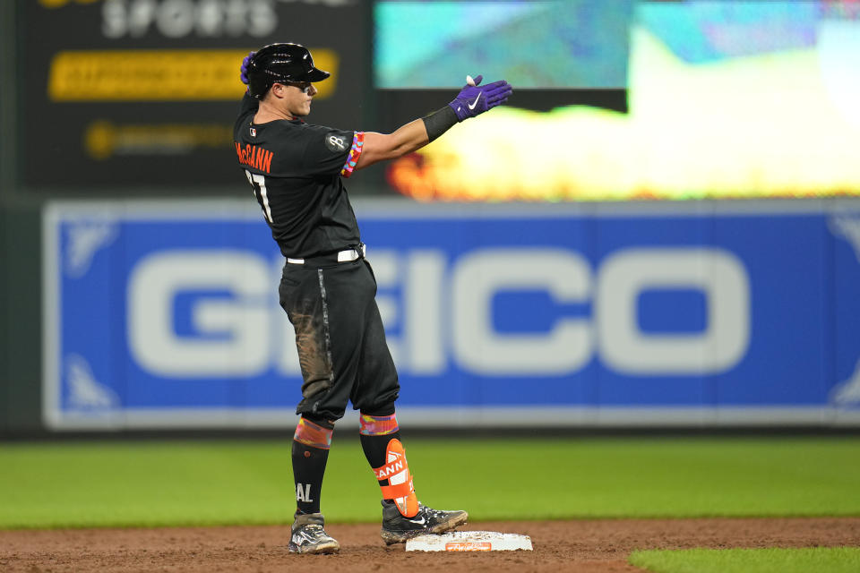 Baltimore Orioles' James McCann gestures after hitting a two-run double to score Colton Cowser and Ramon Urias in the sixth inning of a baseball game against the New York Mets, Friday, Aug. 4, 2023, in Baltimore. (AP Photo/Julio Cortez)