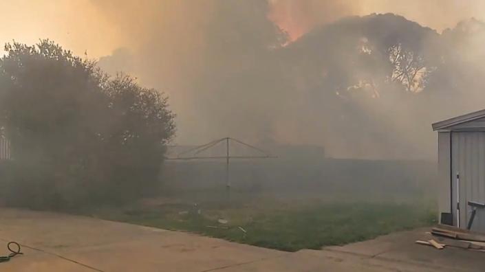Social media video grab shows smoke from bushfires engulfing an area in Paradise City