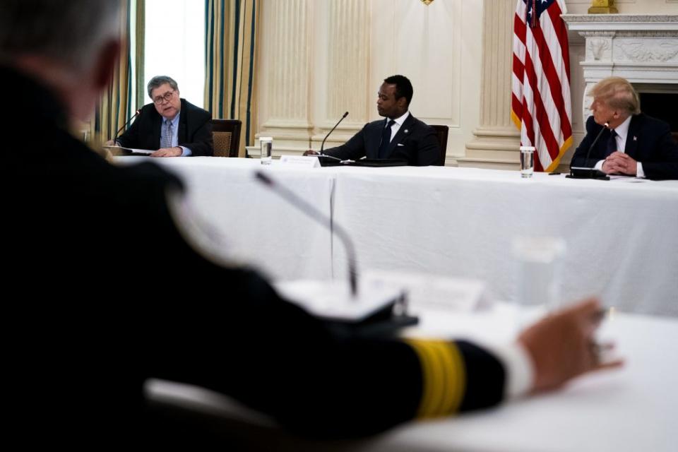 Attorney General William Barr speaks as Daniel Cameron, Attorney General of Kentucky, and U.S. President Donald Trump listen during in a roundtable with law enforcement officials in the State Dining Room of the White House, June, 8, 2020 in Washington, DC. (Photo by Doug Mills-Pool/Getty Images)