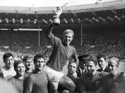 FILE - In this July 30, 1966 file photo England's soccer team captain Bobby Moore, is carried shoulder high by his team mates holding World Cup on July 30, 1966. England defeated West Germany 4-2 in the final, played at London's Wembley Stadium. From left to right, goalkeeper Gordon Banks, Alan Ball, Roger Hunt, Geoff Hurst, Moore, Ray Wilson, George Cohen and Bobby Charlton. English soccer club Stoke said Tuesday Feb. 12, 2019 that World Cup-winning England goalkeeper Gordon Banks has died at 81. (AP Photo/Bippa, File)