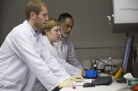 SpacePharma employees work on a miniature laboratory that will carry out experiments in space, in their offices in Herzliya near Tel Aviv February 24, 2015. REUTERS/Amir Cohen