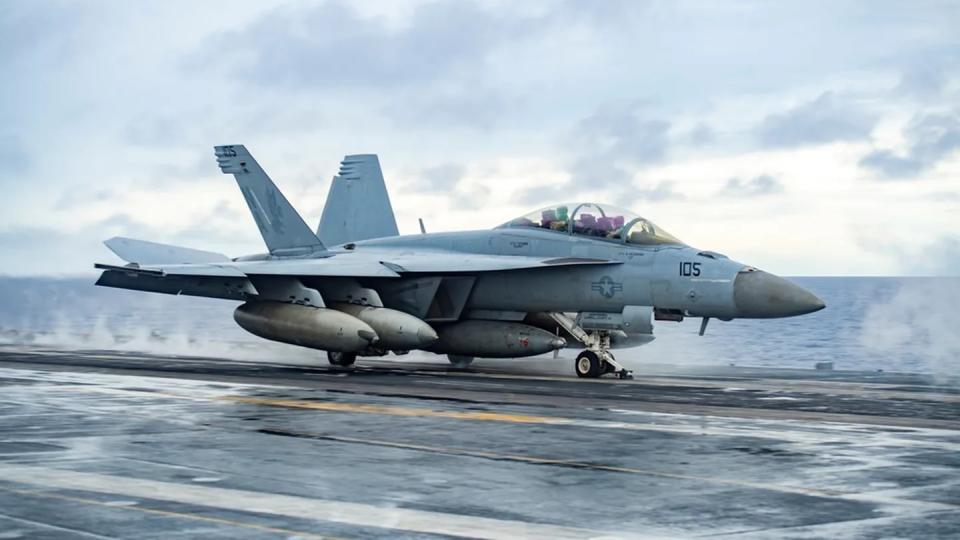 An F/A-18F Super Hornet from the “Fighting Redcocks” of Strike Fighter Squadron 22 launches from the flight deck of the aircraft carrier Nimitz. (MC2 Justin McTaggart/Navy)