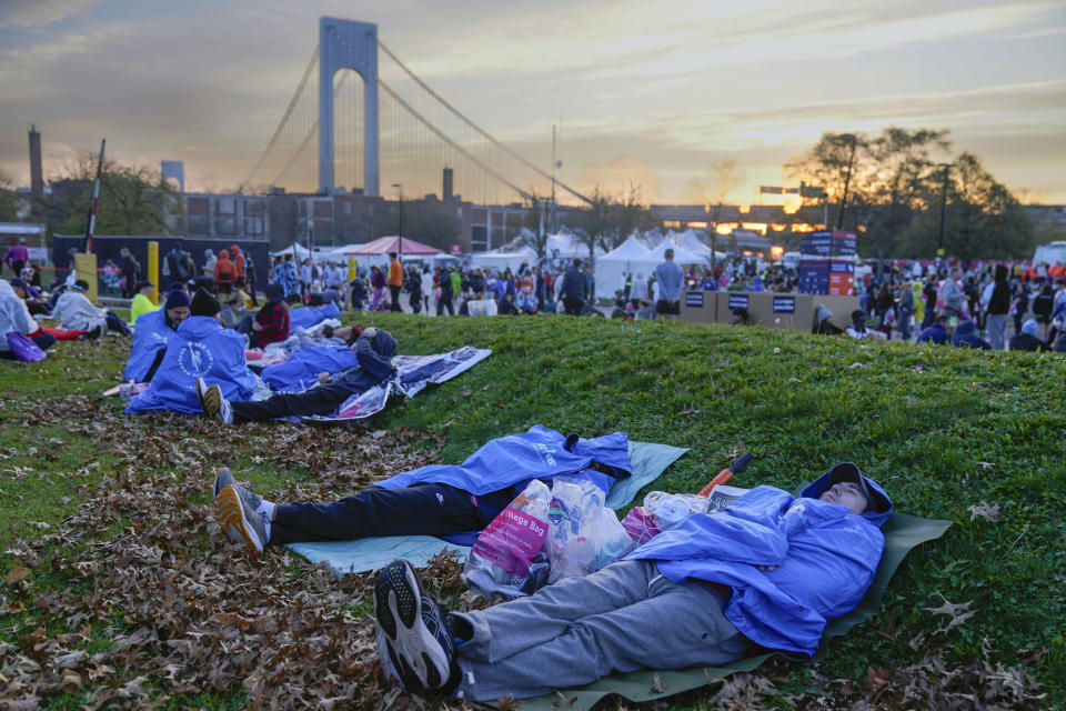 Runners rest before the start of the New York City Marathon in the Staten Island borough of New York, Sunday, Nov. 5, 2023. (AP Photo/Seth Wenig)