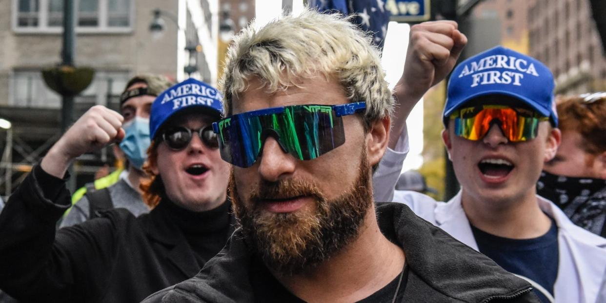 Tim Gionet, better known as Baked Alaska, pictured in sunglasses and cheered on by fellow far right protesters outside Pfizer headquarters on November 13, 2021 in New York City