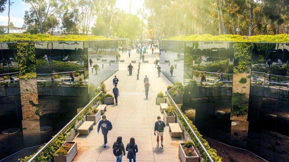 La Jolla, California, USA - April 3, 2017: The mirrored pathway to Geisel Library, the main library at the University of California, San Diego (UCSD), reflecting the students passing by.