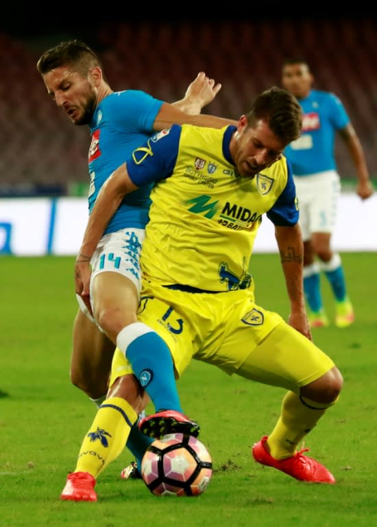 Napoli's forward Dries Mertens (L) fights for the ball with Chievo's midfielder Mariano Izco