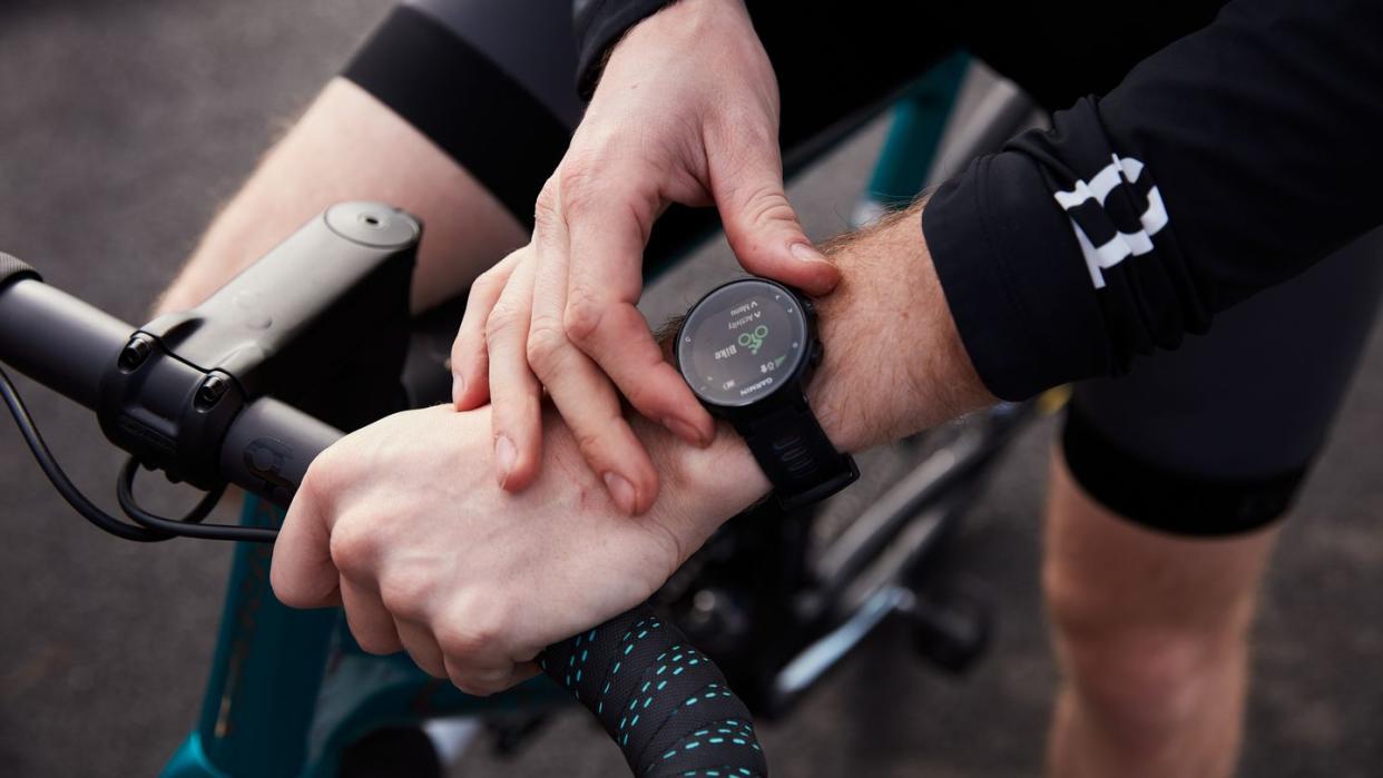 a cyclist starts a garmin watch before a ride