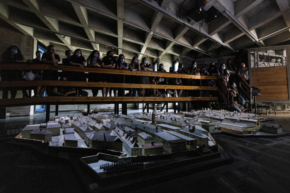 Israeli students look at a model of the Warsaw Ghetto at the museum "From Holocaust to Revival" on the eve of Holocaust Remembrance Day, in Kibbutz Yad Mordechai, Israel, Wednesday, April. 7, 2021. Holocaust remembrance day is one of the most solemn on Israel's calendar with restaurants and places of entertainment shut down, and radio and TV programming focused on Holocaust documentaries and interviews with survivors. (AP Photo/Tsafrir Abayov)