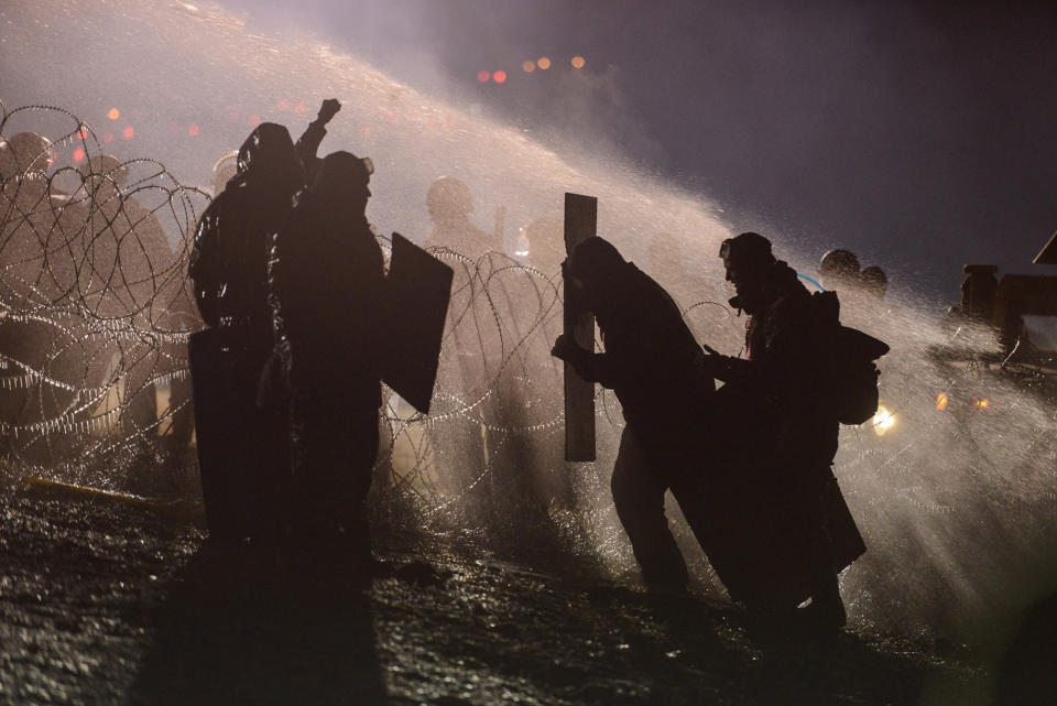 <p>Police use a water cannon on protesters during a protest against plans to pass the Dakota Access pipeline near the Standing Rock Indian Reservation, near Cannon Ball, N.D., on Nov. 20, 2016. (Stephanie Keith/Reuters) </p>