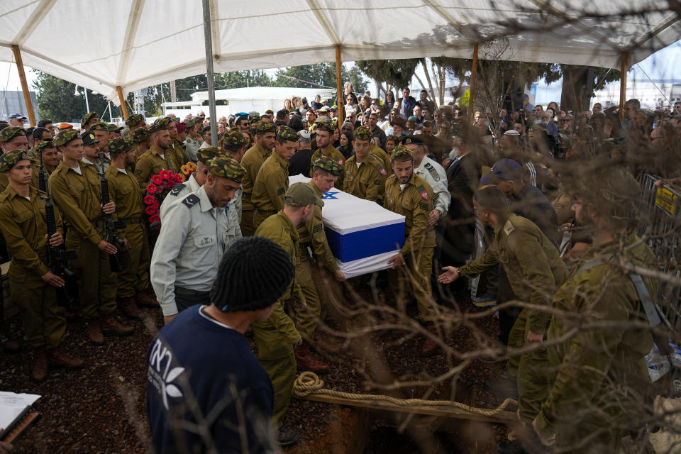 Israeli soldiers carry the casket of Israeli soldier Sergeant Dolev Malca during his funeral in Shlomi, northern Israel, on the border with Lebanon, Sunday, March 3, 2024. Malca ,19, was killed during Israel's ground operation in the Gaza Strip, where the Israeli army has been battling Palestinian militants in the war ignited by Hamas' Oct. 7 attack into Israel. (AP Photo/Ariel Schalit)