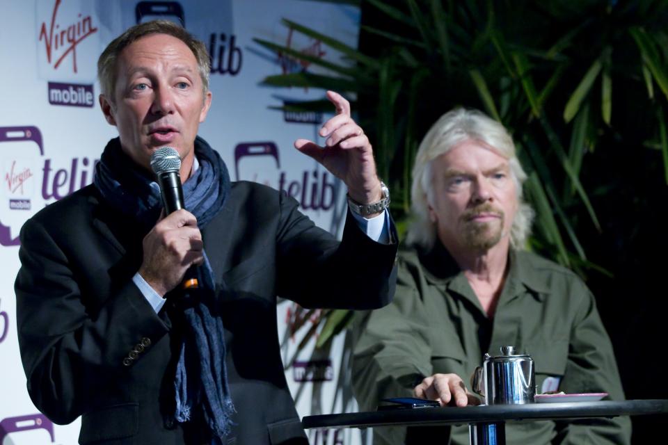 Virgin Mobile France Chief Executive Rialland and business entrepreneur Branson attends a news conference to launch a new service in Paris