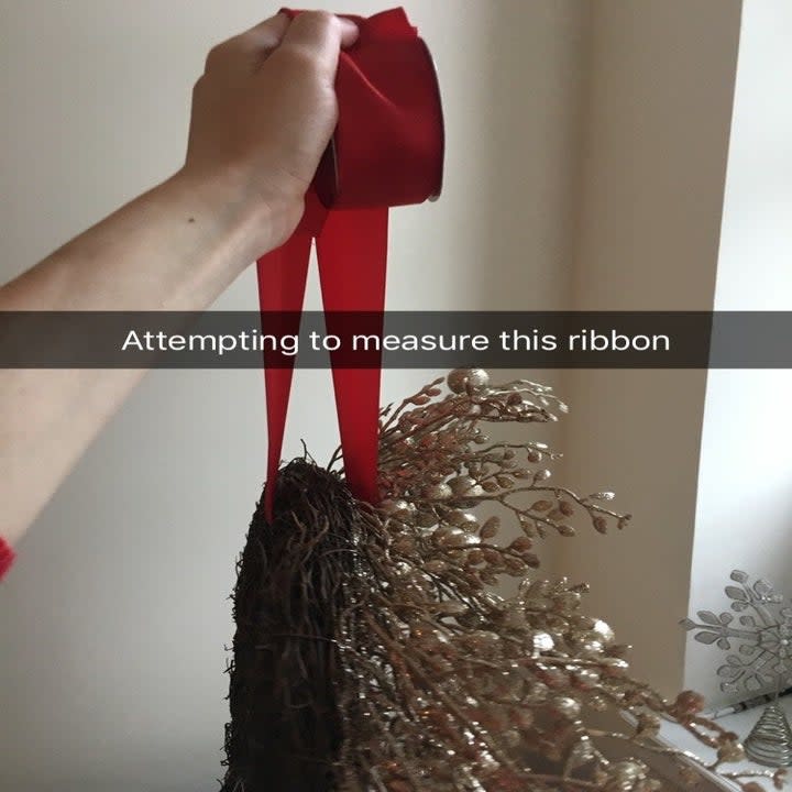 THE IDEA: You can hang a wreath using an upside-down Command hook on the back of your door and some ribbon.