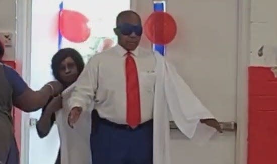 Bishop Samuel Jones Jr. arriving blindfolded at his surprise graduation ceremony.