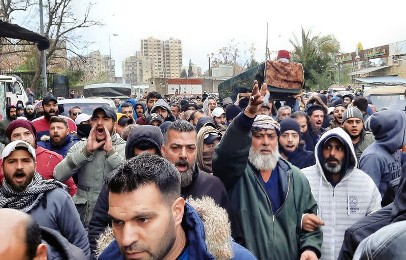 People carry the coffin of a protestor during his funeral in Tripoli