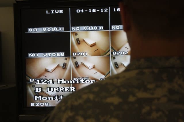 A Guantanamo guard looks over a video screen at Camp VI at Guantanamo in April. Detainees had blocked 147 of the prison's 160 cameras, according to a military official. 