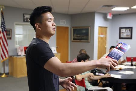 Calvin Lee, executive director for the Art Alas for Congress campaign, speaks with a flyer in hand at a meeting of so-called "Liberty Kids" libertarian Republican activists in Burbank, California, July 27, 2014. REUTERS/David McNew