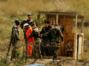 A detainee is taken from a questioning session at camp X-Ray February 6, 2002 in Guantanamo Bay, Cuba. The 156 Al Qaeda and Taliban prisoners are questioned frequently, and are always transported to and from these sessions manacled. (Photo by Chris Hondros/Getty Images)