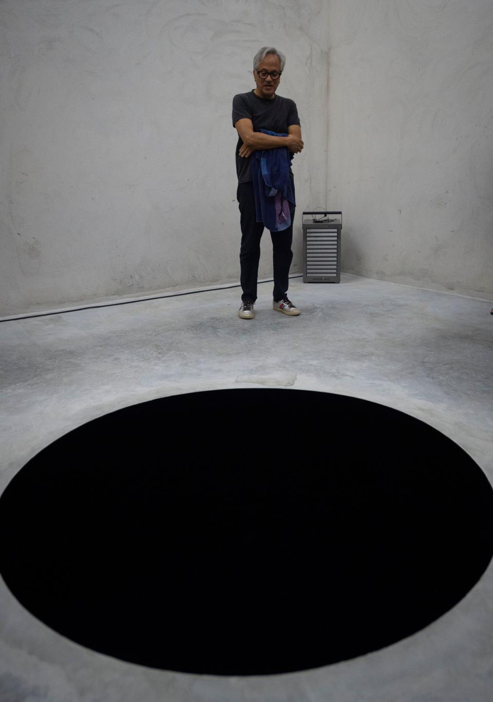 Anish Kapoor stands next to his artwork during the opening of his exhibition <em>Works, Thoughts, Experiments</em> at the Fundação de Serralves in Porto, Portugal, on July 6, 2018. (Photo: Miguel Riopa/AFP/Getty Images)