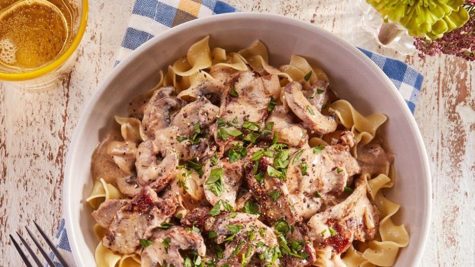 30 minute beef stroganoff in a white bowl with a fork