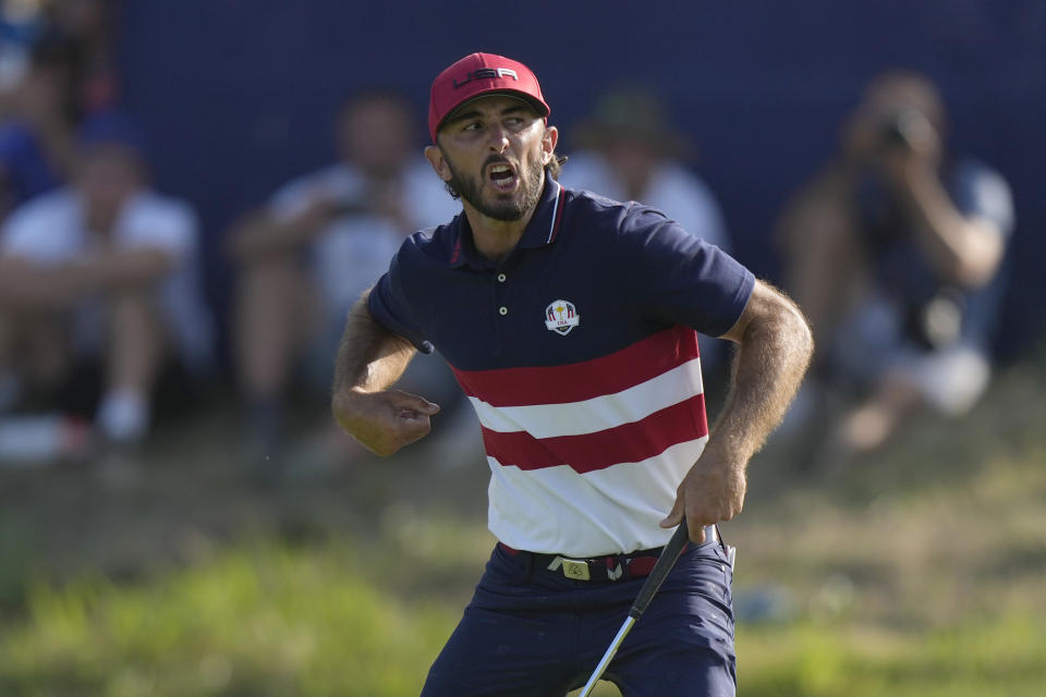 United States' Max Homa celebrates as he wins his singles match 1 up on the 18th green at the Ryder Cup golf tournament at the Marco Simone Golf Club in Guidonia Montecelio, Italy, Sunday, Oct. 1, 2023. (AP Photo/Andrew Medichini)