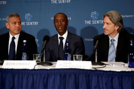 Actors George Clooney (L-R) and Don Cheadle and The Sentry Co-founder John Prendergast discuss The Sentry's investigation of the role of national corruption in the ongoing humanitarian crisis in South Sudan during a news conference at the National Press Club in Washington, U.S. September 12, 2016. REUTERS/Jonathan Ernst