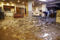 The lobby of a hot-spring hotel is covered with mud after flooding caused by heavy rain in Hita city, Oita prefecture, southwestern Japan, Tuesday, July 7, 2020. Floodwaters flowed down streets in southwestern Japanese towns hit by deadly rains that were expanding across the region Tuesday. (Miyuki Saito/Kyodo News via AP)