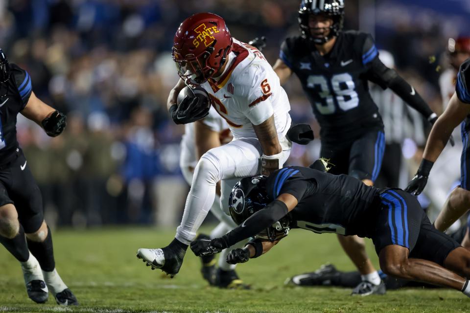 Iowa State Cyclones running back <a class="link " href="https://sports.yahoo.com/ncaaf/players/323535" data-i13n="sec:content-canvas;subsec:anchor_text;elm:context_link" data-ylk="slk:Eli Sanders;sec:content-canvas;subsec:anchor_text;elm:context_link;itc:0">Eli Sanders</a> (6) evades the tackle from BYU Cougars cornerback Jakob Robinson (0) during the game at LaVell Edwards Stadium in Provo on Saturday, Nov. 11, 2023. | Spenser Heaps, Deseret News