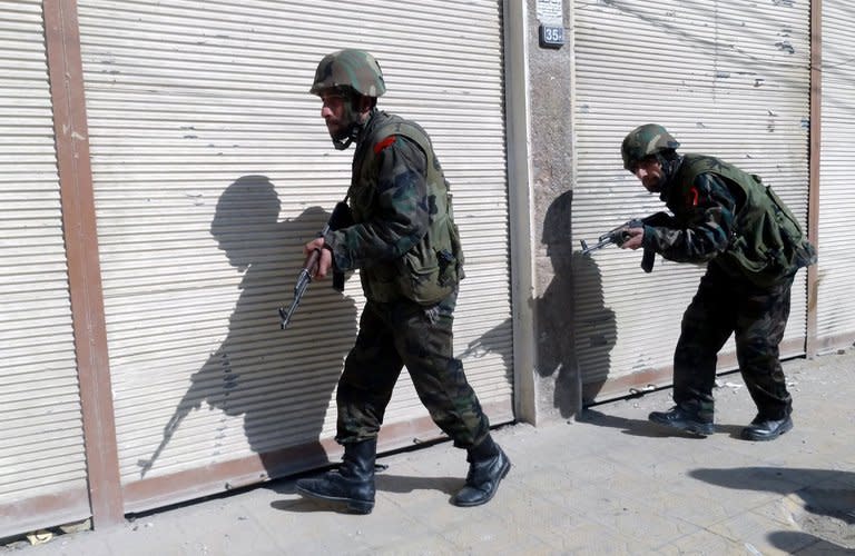 Syrian army forces fight rebels in Daraya, southwestern of Damascus on February 4, 2013, in this photo provided by SANA. In the past the opposition has demanded Assad step down before talks can begin but analysts say Ahmed Moaz al-Khatib's change in stance stems from a belief that the population will be bled dry while the West fails to act