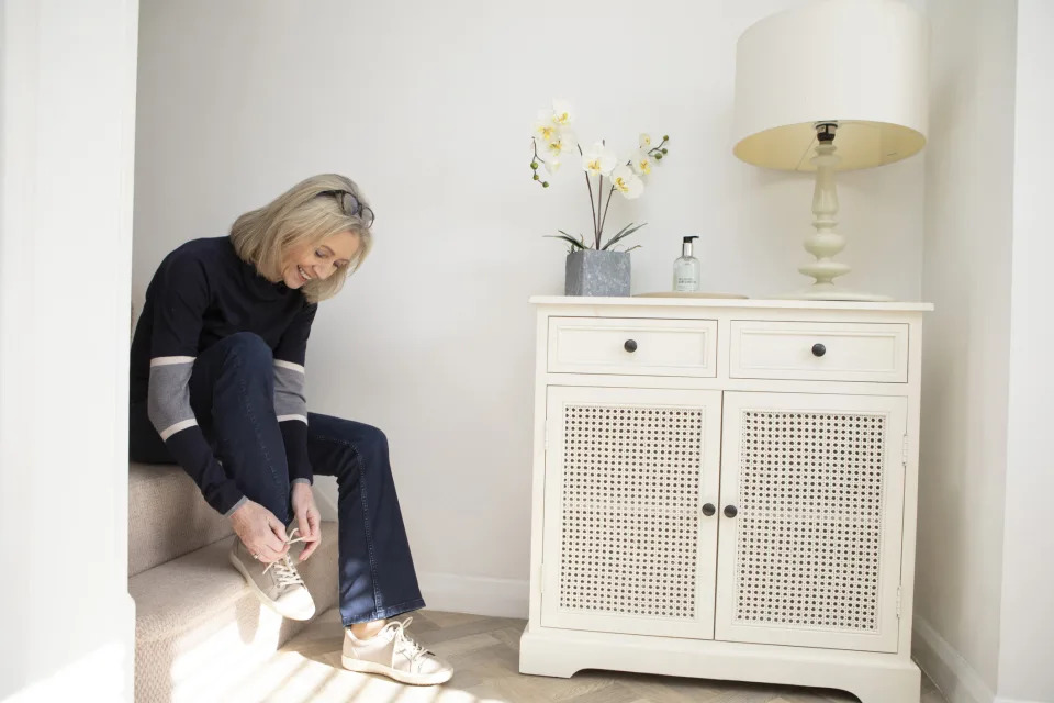 mature woman wearing wide box shoes to ease symptoms of big toe joint pain