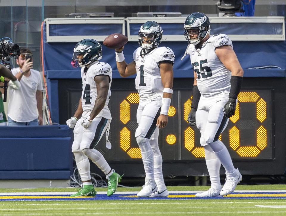 Philadelphia Eagles teammates celebrate with quarterback Jalen Hurts.