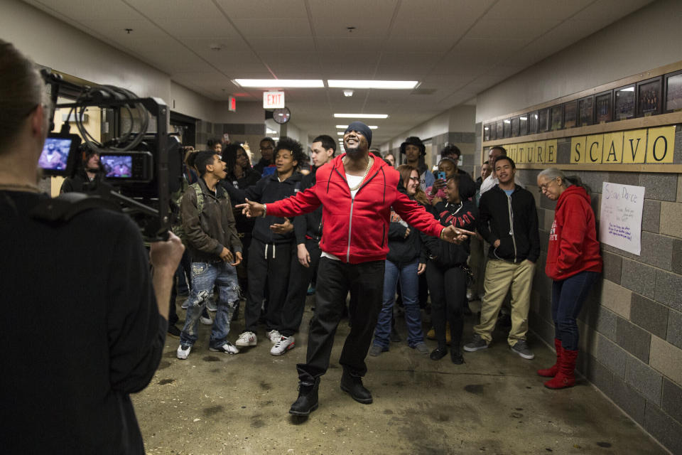 FILE - In this image provided by the Des Moines Public Schools, community activist and rapper Will Keeps records a music video with students in a hallway at Des Moines Public School's Central Campus, Jan. 29, 2016, in Des Moines, Iowa. On Friday, Feb. 3, 2023, Keeps, founder of the Starts Right Here program for at-risk youth in Des Moines, said he will remain “all in on helping kids that are not reachable in so many peoples' eyes” after he was wounded in last month's shooting that killed two of his students. (Jon Lemons/Des Moines Public Schools via AP, File)