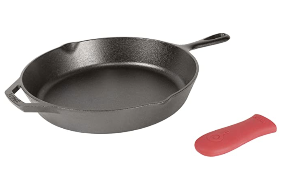 Cast iron skillet with red silicone handle cover next to ti. 