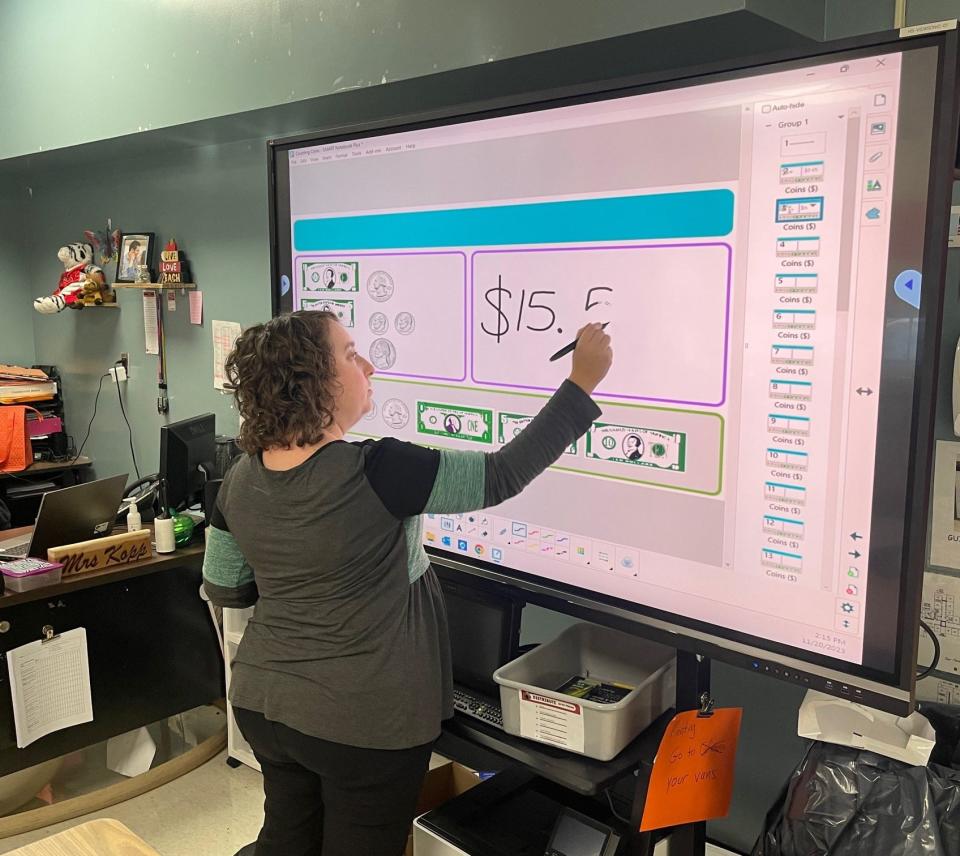 Ashley Kopp, life skills teacher at Conemaugh Township, demonstrates how she uses a ViewSonic Interactive Display to teach students about U.S. currency. This technology will be placed in several classrooms at the middle/high school this year.