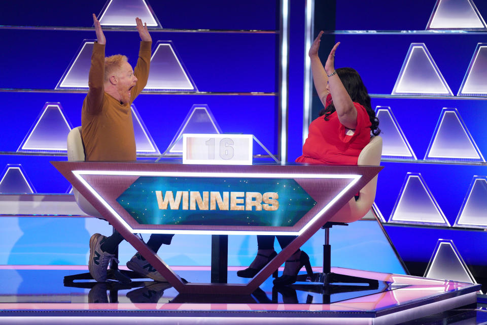 Jesse Tyler Ferguson and Kristina Stasi celeb rate a big win on The $100,000 Pyramid. (ABC)