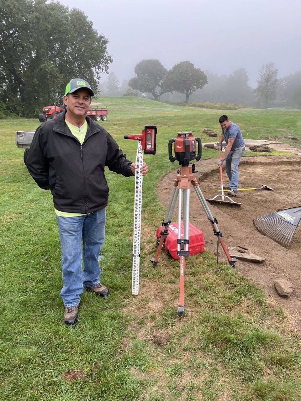 Butch Soto and his crew are renovating all the bunkers at Green Hill Municipal Golf Course. Here, they are working on the fairway bunker on the par-4 15th hole.