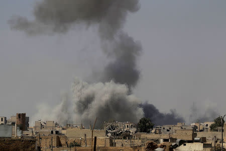 Smoke rises after an air strike during fighting between members of the Syrian Democratic Forces and Islamic State militants in Raqqa, Syria, August 20, 2017. REUTERS/Zohra Bensemra