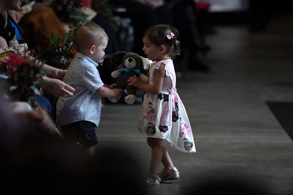 Harvey Keaton (left), son of deceased RFS volunteer Geoffrey Keaton, and Charlotte Charlotte O'Dwyer (right), daughter of deceased RFS volunteer Andrew O'Dwyer share a teddy bear. Source: AAP