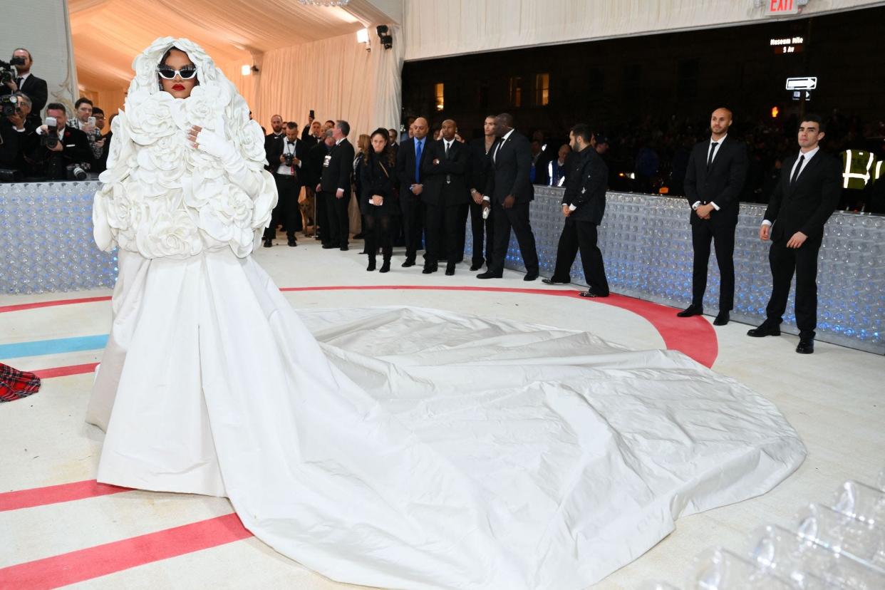 Rihanna wore a dramatic white look to the 2023 Met Gala with a large skirt and floral hooded coat.