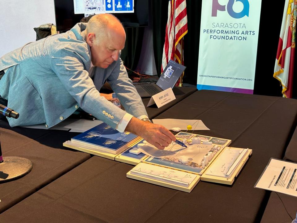 Mark Carroll, a partner with Renzo Piano Building Workshop, sketches out an idea on a model of the site for the new Sarasota Performing Arts Center during a public presentation May 31 at the Van Wezel Performing Arts Hall.