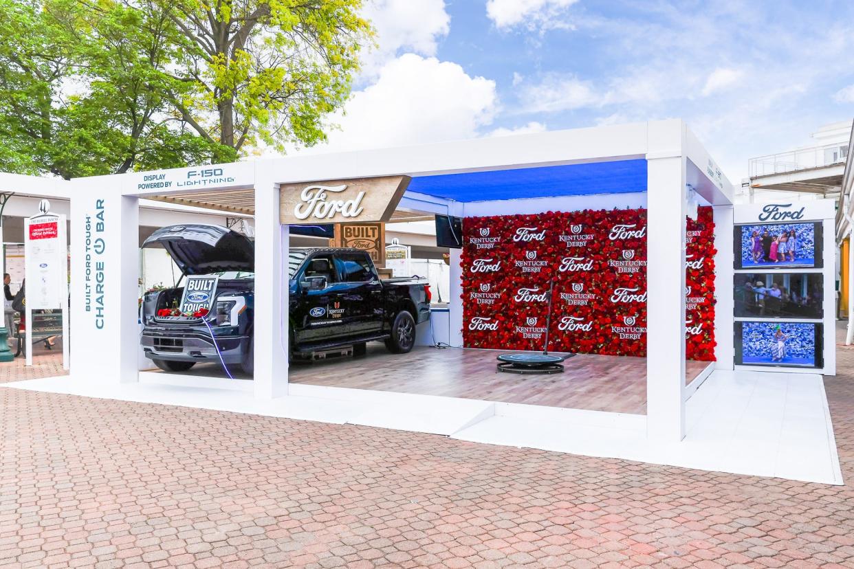 Ford Motor Co. and Churchill Downs Racetrack have a multi-year partnership deal. One aspect of this partnership is Ford's display featuring a flower wall, F-150 Lighting and a phone charging station, in the Paddock Plaza during the Kentucky Oaks and Derby.