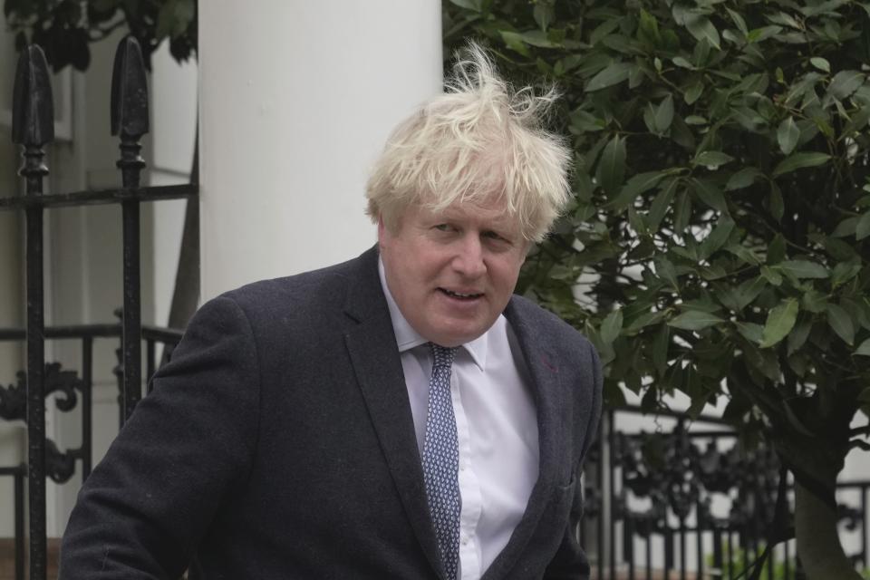 Former British Prime Minister Boris Johnson leaves his home, in London, Tuesday, March 21, 2023. (AP Photo/Kin Cheung)