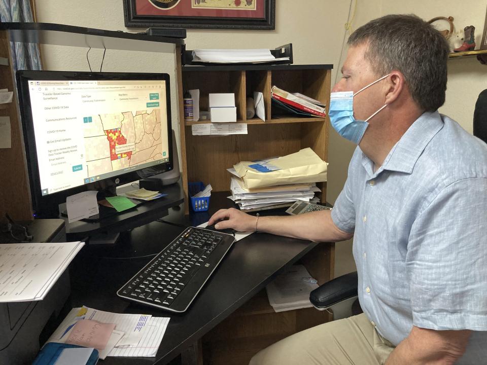 Tim Corbin, administrator of Truman Lake Manor nursing home looks at a map showing COVID-19 transmission levels in Missouri on Feb. 14, 2023, in Lowry, Mo. The nursing home had a COVID-19 outbreak late last year that affected both vaccinated and unvaccinated employees and residents. Corbin believes it's time to end a federal COVID-19 vaccination requirement for health care workers. (AP Photo/David A. Lieb)