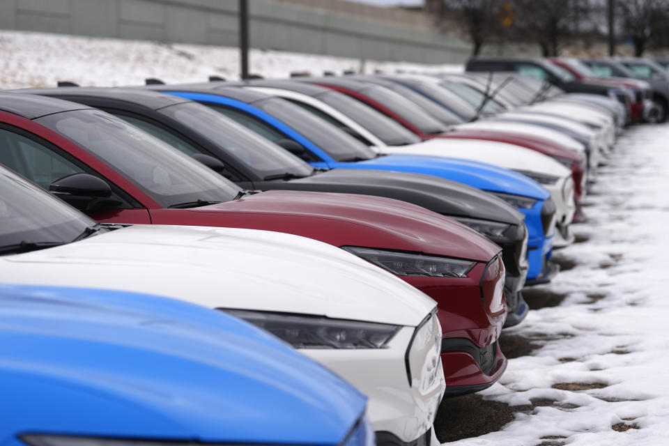 FILE - Unsold 2024 Mustang Mach-E electric vehicles sit at a Ford dealership, Jan. 21, 2024, in Broomfield, Colo. Automobile prices, which had been fueling inflation in the U.S., are starting to drop, helping to slow overall consumer price increases and giving buyers hope of getting a deal. (AP Photo/David Zalubowski, File)