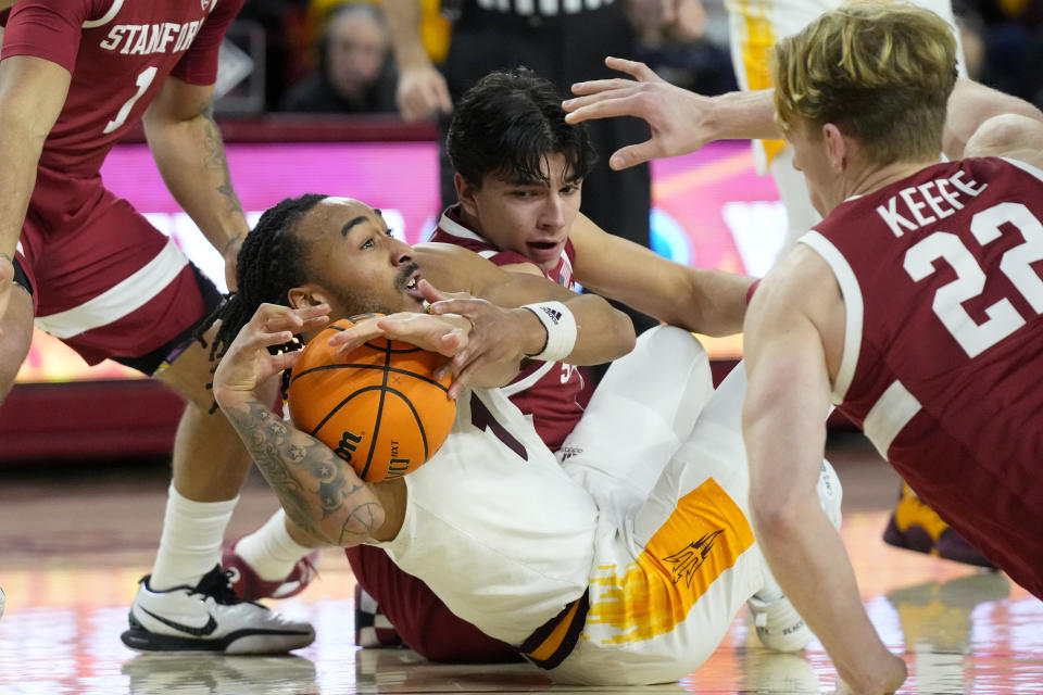 Arizona State guard Frankie Collins (1) tries to keep the ball away from Stanford Cardinal guard Andrej Stojakovic, middle, and Stanford Cardinal forward James Keefe (22) during the first half of an NCAA college basketball game Thursday, Feb. 1, 2024, in Tempe, Ariz. (AP Photo/Ross D. Franklin)