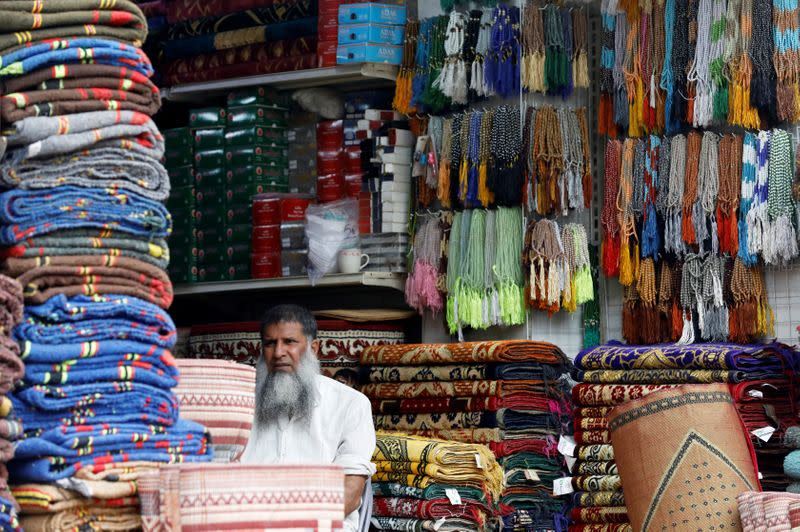 A shopkeeper waits for customers along a wholesale market in Karachi