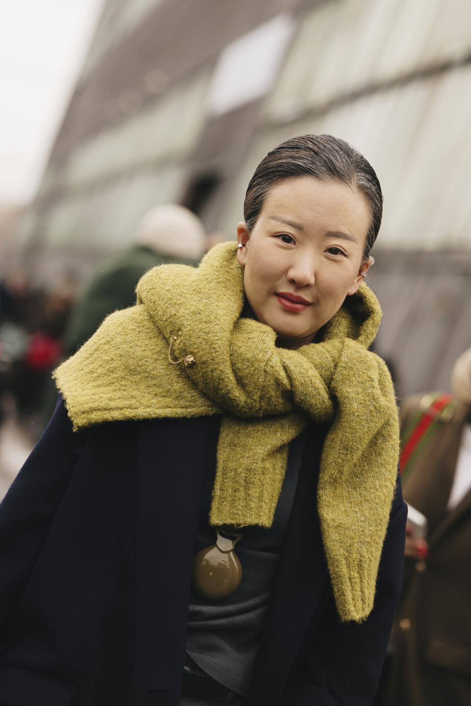 A woman at new york fashion week wearing a brooch in a street style outfit