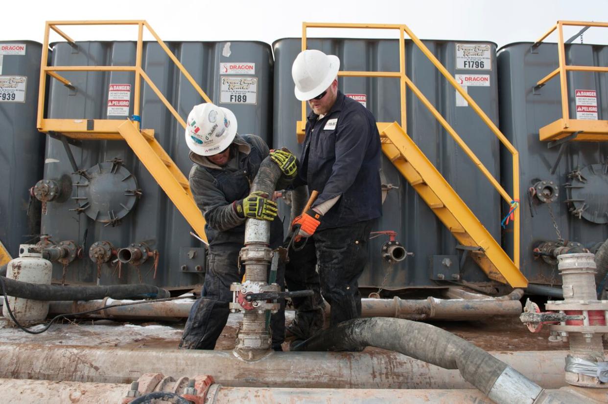 Hydraulic fracturing, known as fracking, injects water, sand and chemicals at high pressure several kilometres underground to break rocks and release natural gas, as shown in this 2014 file photo from North Dakota. (Andrew Cullen/Reuters - image credit)